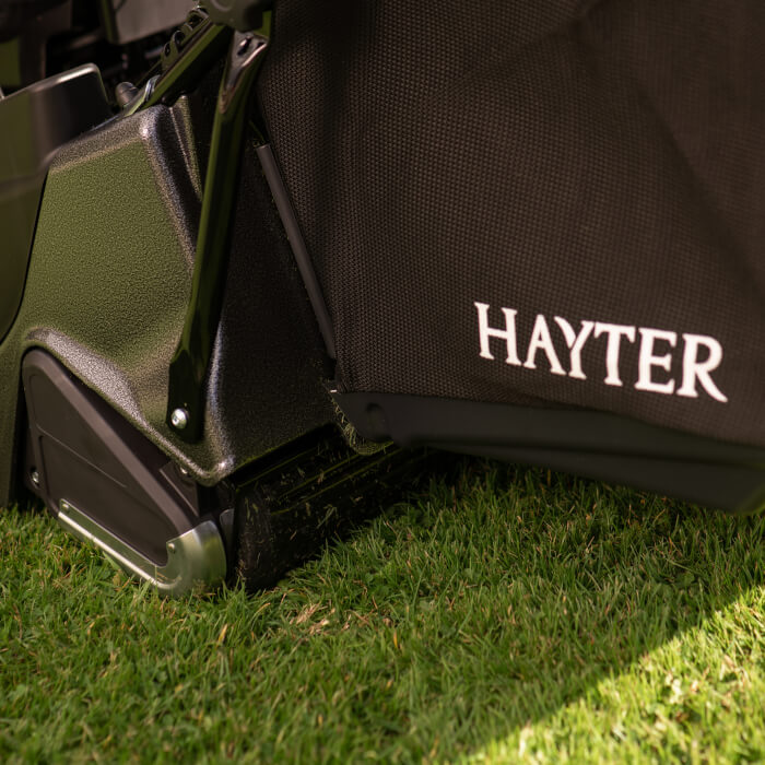 A close-up of the rear roller and grass bag of the Hayter Harrier 56 Pro, showcasing its high-quality materials and design. The roller ensures the signature Hayter striped finish for a professional-grade lawn appearance.